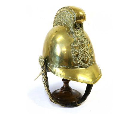 A Pre-War Merryweather Brass Fireman's Helmet, each side of the raised comb embossed with a dragon, the helmet plate stamped 