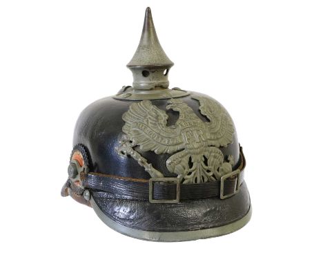 A First World War Prussian EM's Pickelhaube, of black leather with magnetic grey metal fittings of detachable spike with bayo