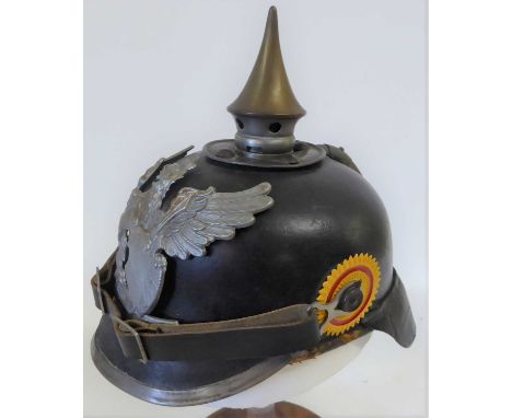 An Imperial German Model 1915 Enlisted Man's Pickelhaube, in black leather with magnetic grey metal mounts including Baden gr