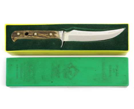 A Puma Skinner Knife, with 13cm up-turned double edge steel blade, the aluminium crossguard numbered 29771, with stag horn gr