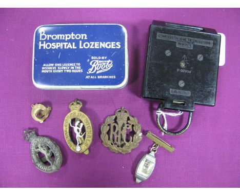 A Mid XX Century British Army Marching Compass Mk.1, by T.G. Co. Ltd; plus cap badges and associated items.