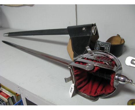 A Reproduction Basket Hilted Broadsword (Claymore), double edged blade, polished steel and pierced hilt with red leather padd