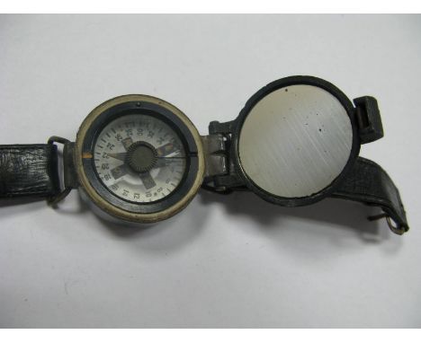 A XX Century Wrist Compass, with black leather wrist strap, War Department arrow on reverse, Ref. No. 6B/2593.