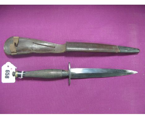 A Mid XX Century Fairburn Sykes Fighting Knife, grip stamped with War Department Arrow and "B", in leather scabbard.