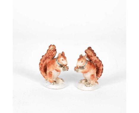 A pair of small Derby squirrels, circa 1800, each seated holding a nut, turquoise collars, patch marks, 8.5cm highOne with a 