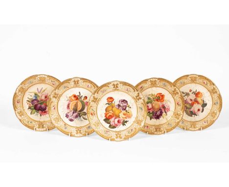 Five Coalport dessert plates, circa 1820, each painted with a generous bouquet of flowers and fruit within a wreath-moulded b