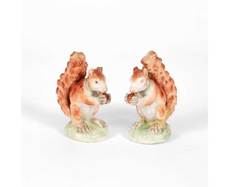A pair of large Derby squirrels, circa 1800, each seated with a nut, turquoise collars, patch marks to base, 11cm highboth wi