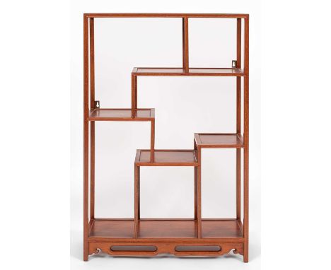 A Chinese hardwood display shelf, the arrangement of shelves between fluted supports and a pierced apron, 56cm wide, 18cm dee