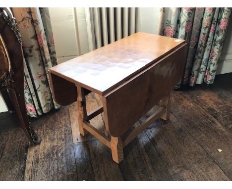 A small drop-leaf light oak table by Colin Almack "The Beaver Man" circa 1980, apprentice to the Robert “ Mouseman “ Thompson