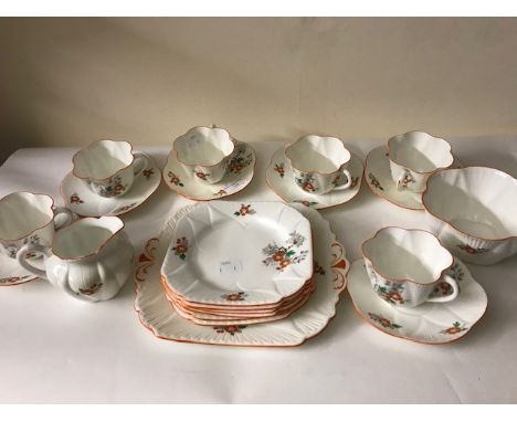 An early 20th century Shelley tea set, red flower design, including 6 tea cups and 6 saucers, 6 side plates, sugar bowl and m