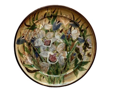 A late 20th Century Art Nouveau style ceramic charger by Joyce Morgan depicting irises and other flowers, 49cm diameter, sign