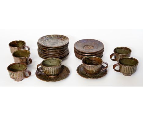A Mid Century Nigerian Abuja Stoneware Pottery Coffee set with 7 cups, 8 saucers and 8 side plates, Running ash glaze.