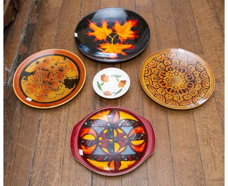 A group of 20th century Poole Pottery pieces, including hand pained floral footed bowl, 17cms diam approx. plate with an abst