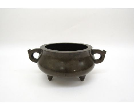 A Chinese tripod censer, seal mark to base, 8cm tall 