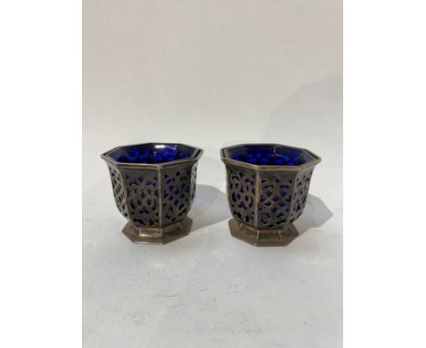 A pair of Victorian Henry Wilkinson &amp; Co silver pierced condiment pots of octagonal form with blue glass liners. Both wit