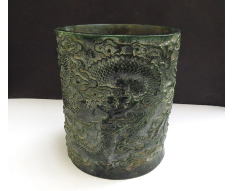 A Chinese jade brush pot decorated with a Ho-Ho bird and mythical dragon, impressed seal mark to base, 15cm tall, 11cm x 12.5