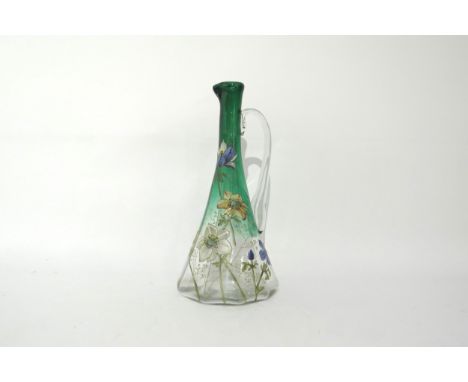 A late 19th Century faceted jug. Hand painted enamel floral detail, possibly Emile Galle, 26cm tall 