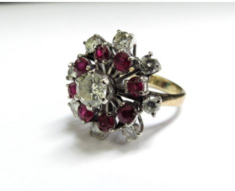 A ruby and diamond cocktail ring, the centre diamond 0.75ct approx surrounded by eight rubies and eight diamonds to outer, un