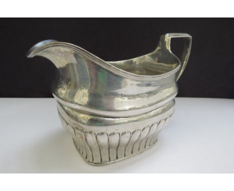 An early 19th Century Irish silver milk jug, stirrup handle and fluted detail, sea creature designed engraving, Dublin 1807 m