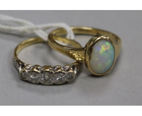 An 18ct gold and graduated five stone diamond ring and a 9ct gold and white opal ring.