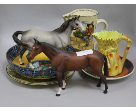 A group of assorted ceramics including two Beswick horses, a Doulton anglers jug and a Poole dish