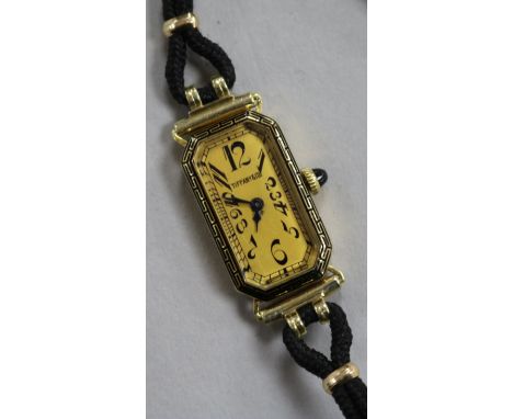 A lady's 18ct gold Longines manual wind wrist watch retailed by Tiffany & Co, on fabric strap.