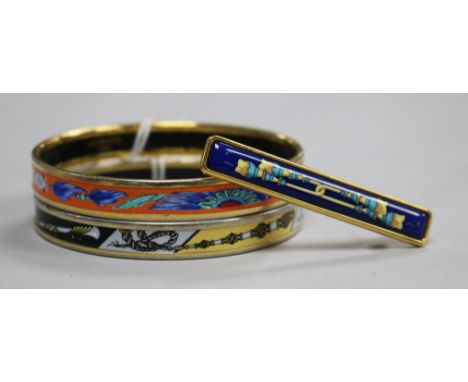 Two Hermes of Paris, gilt metal and enamel bangles (both made in Austria) and a Hermes of Paris enamelled brooch.