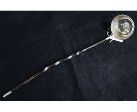 An 18th century white metal toddy ladle, with inset coin bowl and baleen handle, 36.6cm.