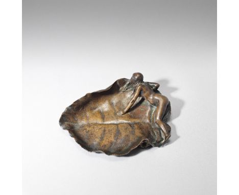 Maurice BouvalArt Nouveau Vide poches, circa 1900Patinated bronze, cast from a model with a naked woman reclining on a leaf.1
