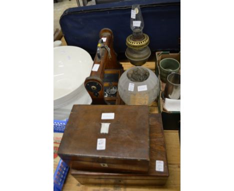 Two sewing boxes, a tantalus frame and an oil lamp.