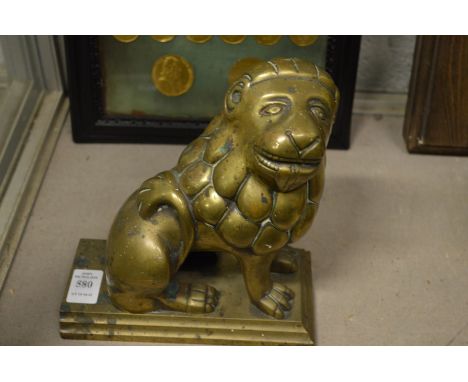 A bronze model of a lion.