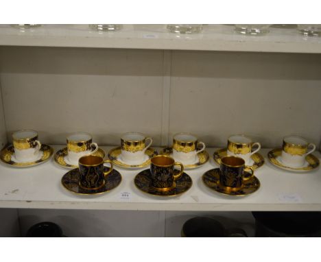 A set of six Aynsley coffee cans and saucers and three gilt decorated coffee cans and saucers.