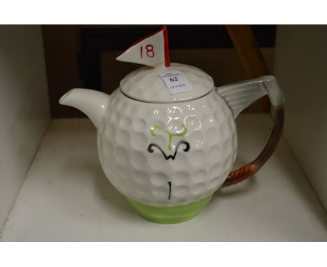 A Tony Wood novelty teapot in the form of a golf ball and putter.