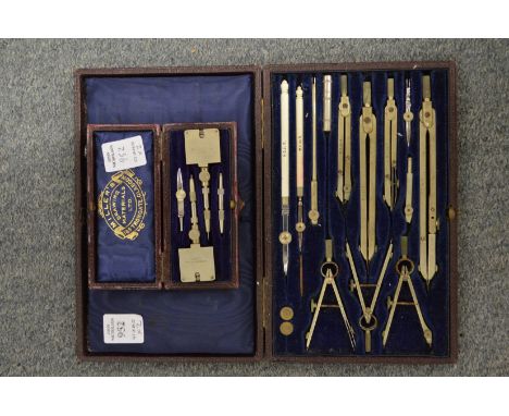 A leather cased drawing instrument set and a similar item.