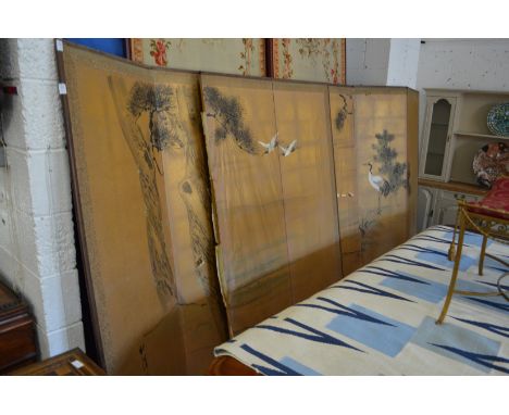A pair of Japanese gilt paper and painted six panel folding screens decorated with herons and trees.