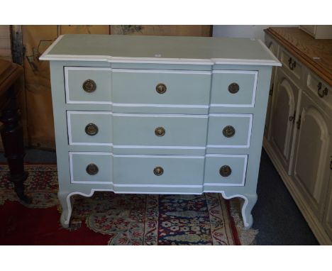 A cream and gilt painted three drawer commode.