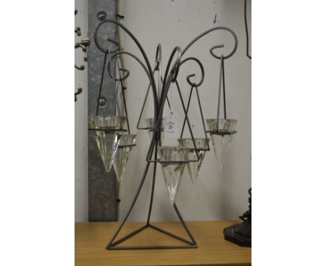 An ornate wrought iron and glass tea light holder.