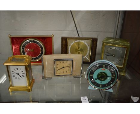 A collection of decorative mantle clocks to include a brass carriage clock.