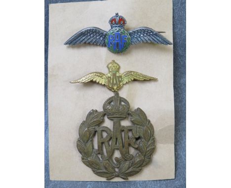 A SILVER &amp; ENAMEL R.A.F. BADGE, together with a gilt RAF badge and an RAF metal cap badge, average 5 cm