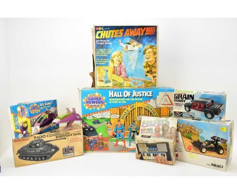 Six vintage boxed games and remote controlled vehicles comprising Kenner Hall of Justice Headquarters for the Battle of Good 