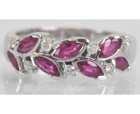 Standard VAT An 18ct white gold ruby and diamond leaf designed ring, set with six marquise cut rubies and six round brilliant