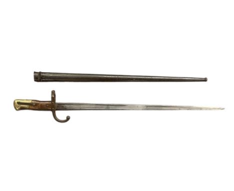 A late 19th century French bayonet, the blade inscribed and dated 1878, length of blade 52cm, length of scabbard 53.5cm, over