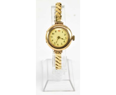A lady's vintage 9ct gold wristwatch, the white enamel dial set with Arabic numerals and red 12 o'clock, with outer gold dot 