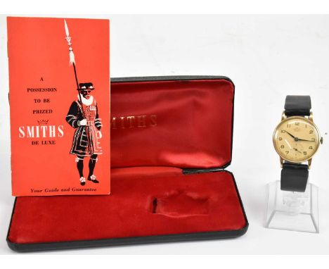SMITHS; a gentleman's vintage 9ct gold Deluxe 15 jewel movement wristwatch, the champagne dial set with Arabic numerals and s