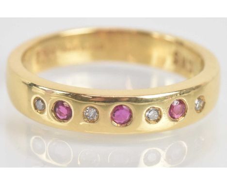 Standard VAT An 18ct yellow gold diamond and ruby ring set with four round brilliant cut diamonds and three round cut rubies,