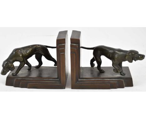 A pair of early 20th century Art Deco bronze bookends, decorated with bronze models of dogs, one inscribed to base 'Fashioned