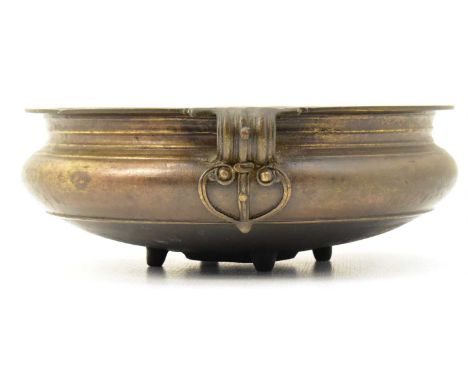A large bronze censer of shallow form, raised on four stub feet, unmarked, height 9.5cm, diameter 25.5cm.