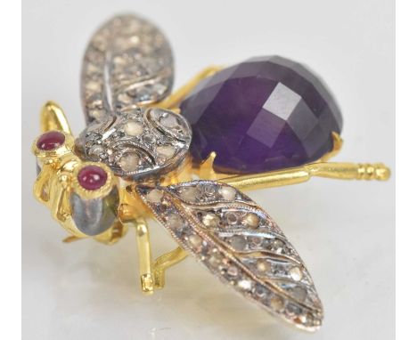 A yellow metal brooch modelled as a butterfly, set with large amethyst body, small diamond encrusted wings and cabochon ruby 