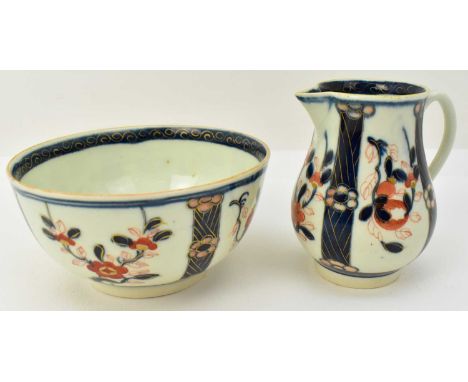 An 18th century porcelain sparrow beak cream jug and small bowl with matching pattern depicting Imari theme of orange, blue a