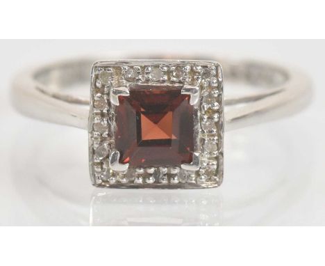 Standard VAT A 9ct white gold ruby and diamond ring in square setting, the total diamond weight 0.050ct, size N 1/2, approx 2
